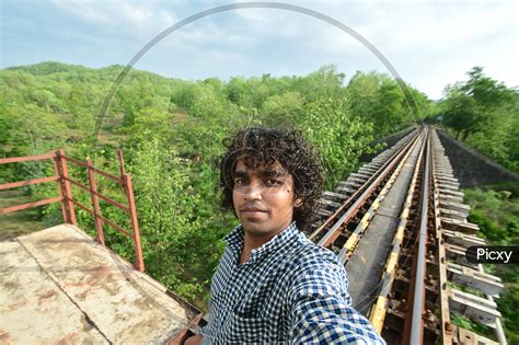Image Of A Young Indian Man Taking Selfie On A Railway Bridge Eq213771 Picxy