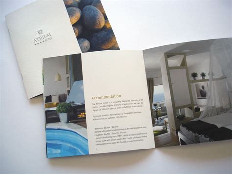 An Open Brochure Showing The Inside Of A Hotel Room With Blue And White