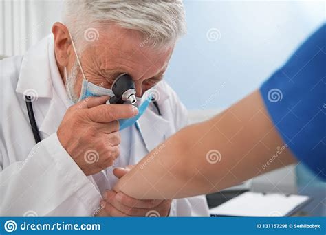 Doctor Diagnosing Disease Of Skin On Patient`s Hand Stock Photo