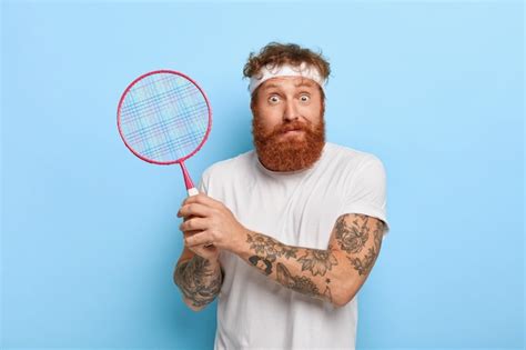 Free Photo Horizontal Shot Of Scared Red Haired Tennis Player Holds