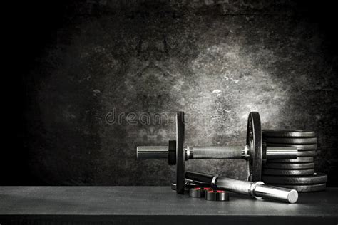 Dumbbell Barbell And Workout In The Gym Copy Space On Black Grunge