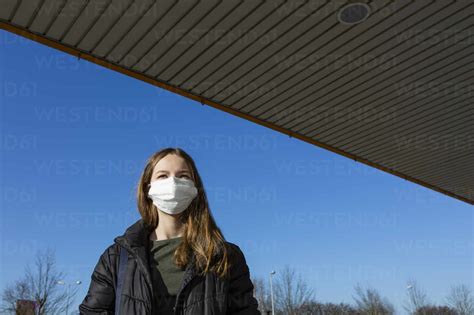 Portrait Of Girl Wearing Mask Outdoors Stock Photo