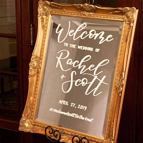 A Wedding Welcome Sign Hanging From A Door