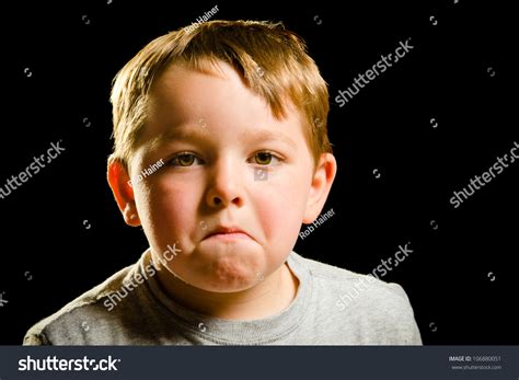 Portrait Of Serious Sad Angry Or Depressed Child Isolated On Black