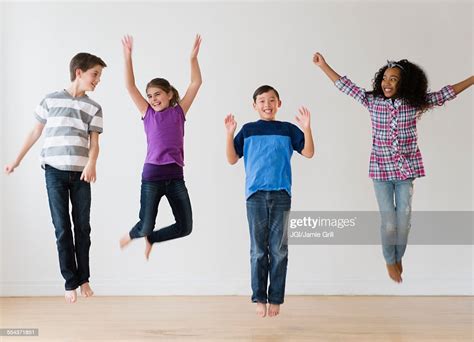 Smiling Children Jumping For Joy In Studio High Res Stock Photo Getty