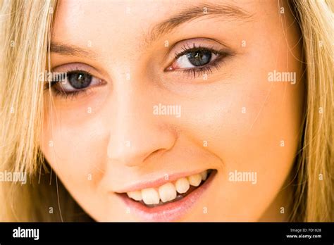 close up of face of very pretty 16 18 year old blonde girl with blue eyes eye contact and big