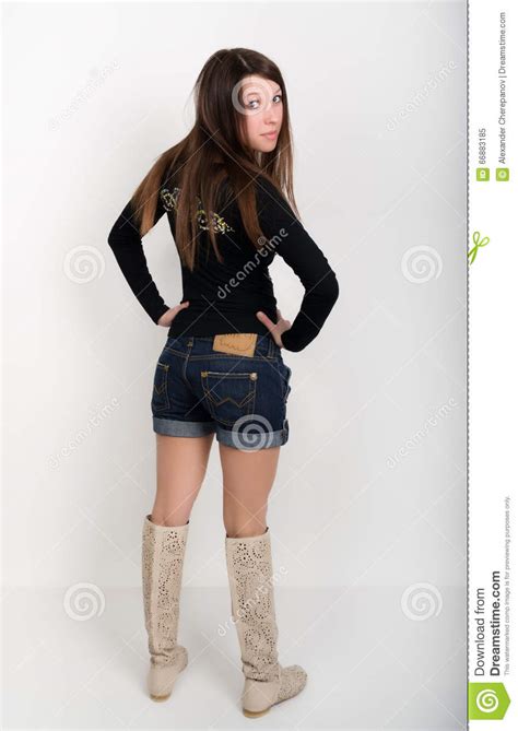 Girl In Denim Shorts T Shirt With Long Sleeves And Boots