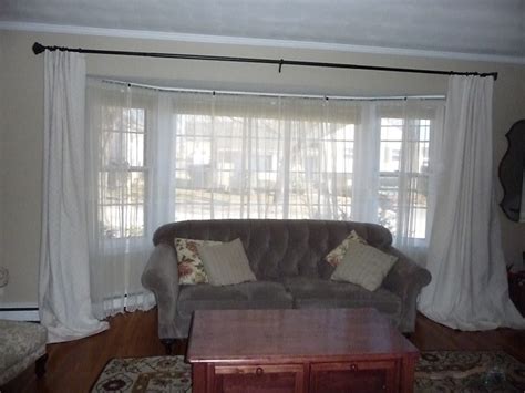 Roman shades and drapery are a chapter 5: test: Window treatments for a bay window.