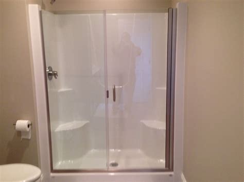 Frameless Shower Door And Panel On A Fiberglass Shower Stall Contact