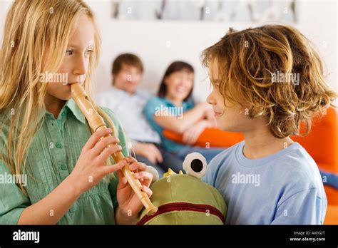 Boy 6 7 And Girl 8 9 Playing Recorder Stock Photo Alamy
