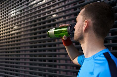 Caucasian Man Drinking Water During Exercises Stock Photo Download