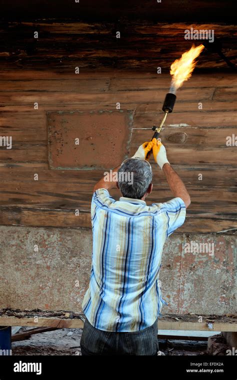Turkish Worker Using A Blow Torch To Strip Paint From A Wooden Hull In