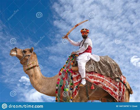 Indian Rajasthani Man In Traditional Clothes Poses For A Photo During Bikaner Camel Festival In
