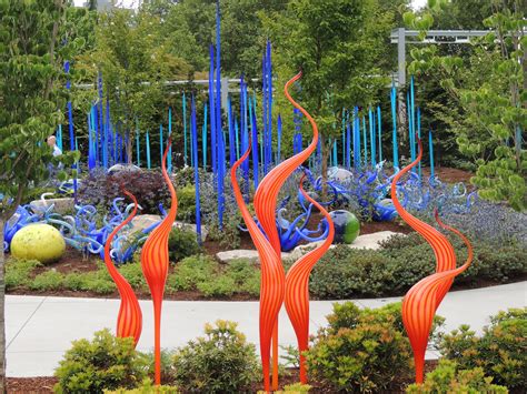 An Artistic Garden With Blue And Orange Sculptures