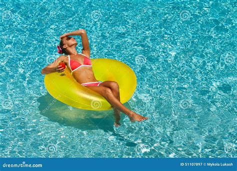 Woman In Bikini Enjoying Summer Sun And Tanning During Holidays In Pool