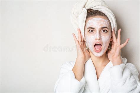 Surprised Brunette Model With Moisturizing Cream Mask And Bath Towel On Head Empty Space Stock