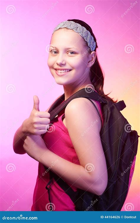 Teen Girl Goes To School With A Backpack On Her Back Stock Photo