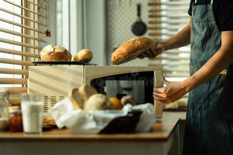 Male Baker Taking Freshly Baked Bread From The Oven Healthy Eating