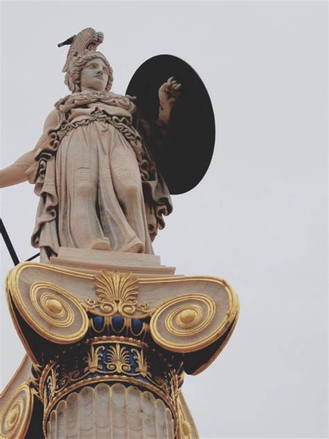 An Image Of A Statue That Is On Top Of A Building In The Day Time