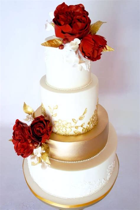 Red Flower Topped Gold And White Wedding Cake Wedding