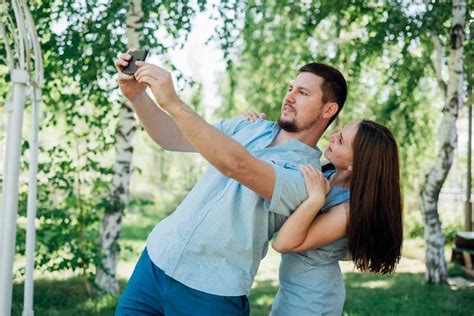 Free Photo Joyful Couple Taking Selfie In Birch Forest