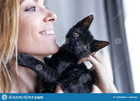 Beautiful Young Woman At Home Holding And Hug Her Lovely Fluffy Cat