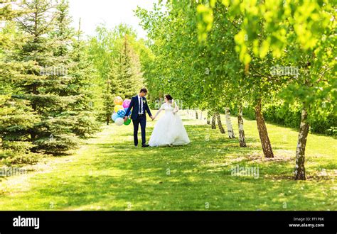 Beautiful Bride And Groom With Colorful Balloons Stock Photo Alamy