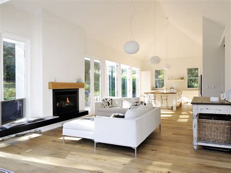 Open Plan Living Room Using White Colours With Floorboards And Bi Fold