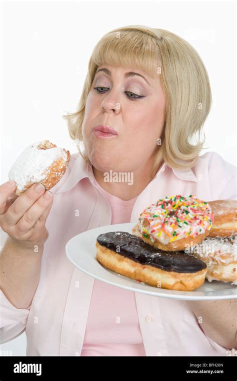 Woman Eating Donuts Stock Photo Alamy