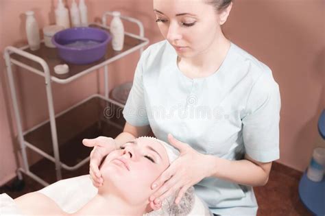 Professional Masseur Woman Making Facial Massage To Client In Spa Salon Stock Image Image Of