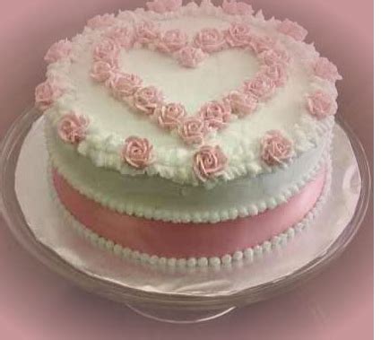 Birthday cake for valentines day. Round white valentine cake with light pink cake decor.PNG