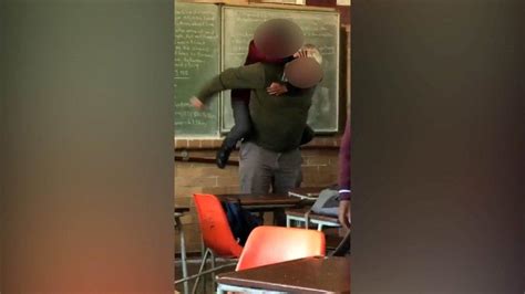 Pupil Jumps On Teachers Back During Chaotic Classroom Brawl In
