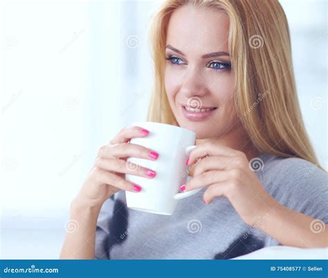 Young Beautiful Woman With A Cup On Sofa At Home Stock Image Image Of