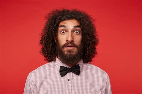 Free Photo Close Up Of Amazed Young Brunette Curly Man With Beard
