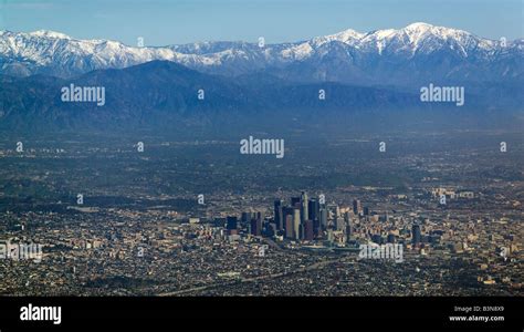 Aerial View Above Downtown Los Angeles With Snow Covered San Gabriel