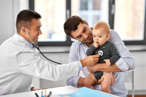 Father With Baby And Doctor At Clinic Stock Image Image Of Adult