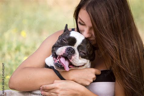 Young Girl Kissing Her Dogdog Lover Girl Kisses Bulldog Puppy In Sunny