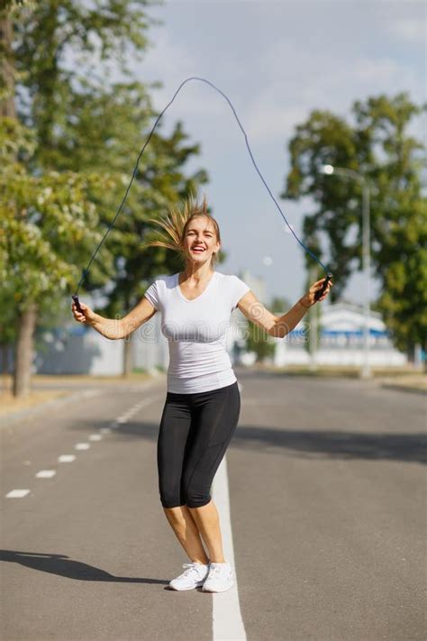 Athletic Young Woman Training With A Jumping Rope On A