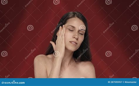 A Woman Takes Care Of Her Skin Applies Cream On Her Face Portrait Of