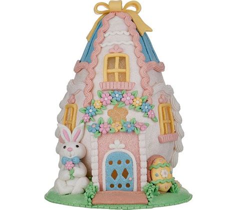 A Ceramic House With An Easter Bunny In Front