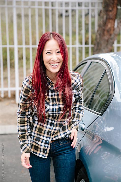 Pretty Asian Redhead Smiling And Laughing By Curtis Kim Stocksy United