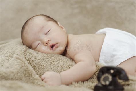 Close Up Photo Of Face Of An Asian Newborn Sleeping Happily Stock Photo