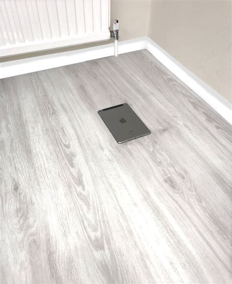 In your head you might picture your grandparents black and white checkered kitchen floor or your groovy uncles house covered in orange and yellow linoleum topped with shag rugs. White LVT Vinyl Click Plank Flooring - 4.2mm Thick - Water Resistance