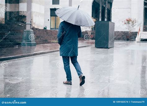 Man Walking In The City With Umbrella On Rainy Day Stock Photo Image