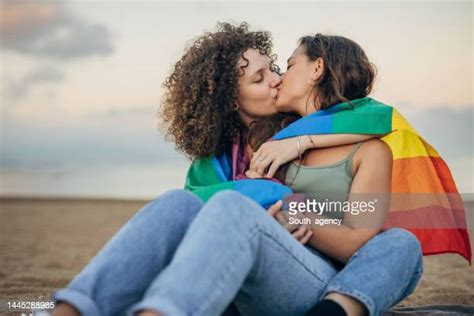 Young Romantic Lesbian Couple Kissing At Sunset On Seaside Photos And Premium High Res Pictures