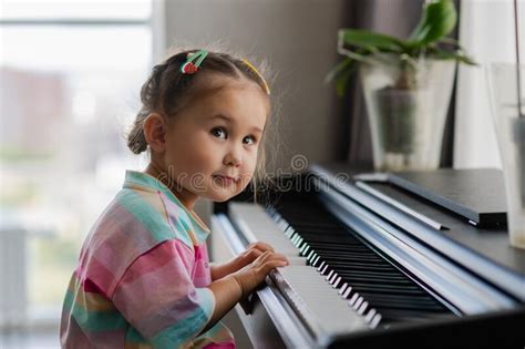 Cute Little Girl Playing Piano At A Music School Stock Image Image Of