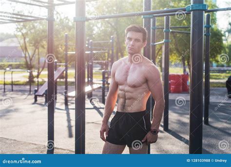 Muscular Fitness Male Model Posing Shirtless Demonstrating Six Packs