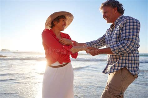 sunset love a mature couple enjoying a late afternoon walk on the beach stock image image of