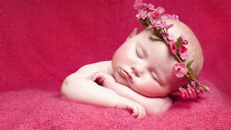 Start by uploading your photo or taking a selfie. cute baby is sleeping on red towel and having flower crown ...