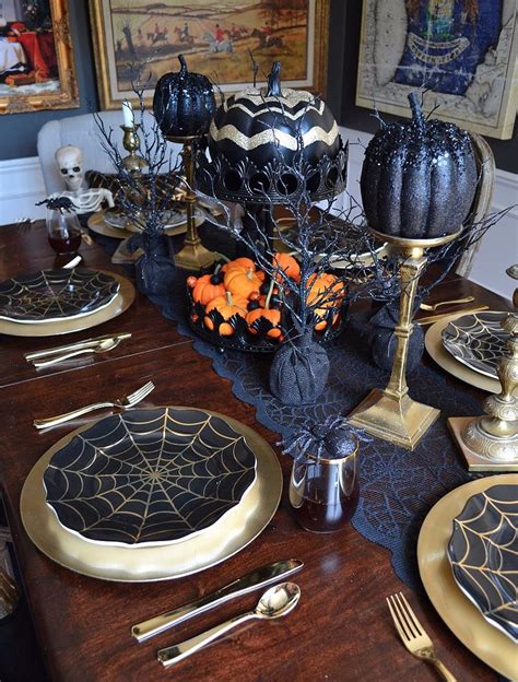 A halloween centerpiece of black cheesecloth, glitter skulls, gilded skeleton hands, black wax a black cardboard tree with pumpkins, blackbirds, skeletons and hay is a creative halloween decoration or centerpiece. 30 Tips For Fabulous Fall Decor {Halloween Tablescape ...